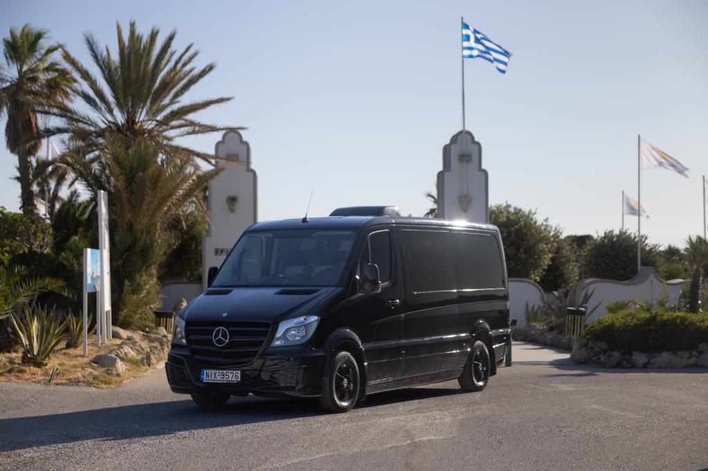 Tesla electric vehicle exterior — eco-friendly Rhodes transfer